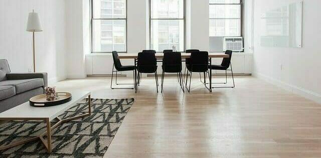 Image of modern apartment dinning room with an 8 chair seating table.