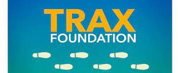 Trax Foundation Logo with Yellow and white text on a blueish background. 